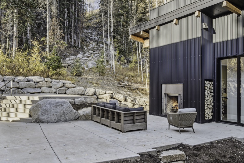 Patio with seating and fireplace