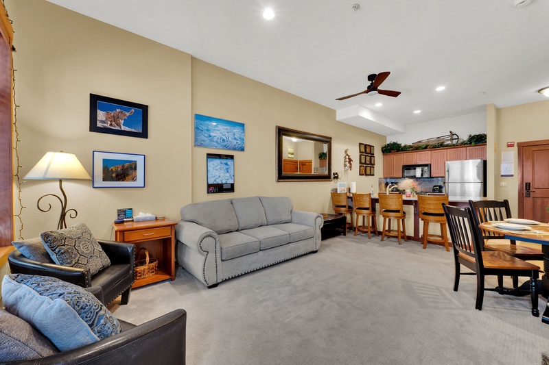 Cozy living room with couch, armchairs and small dining table.