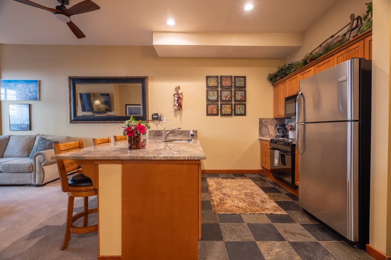 Kitchen counter has plenty of space and seating for 4