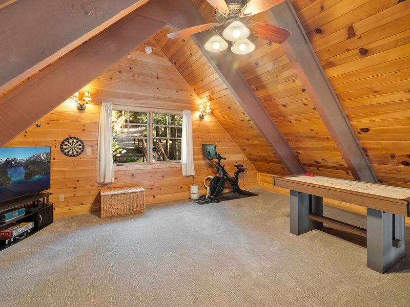 Upstairs loft with TV, air hockey, and a Peloton