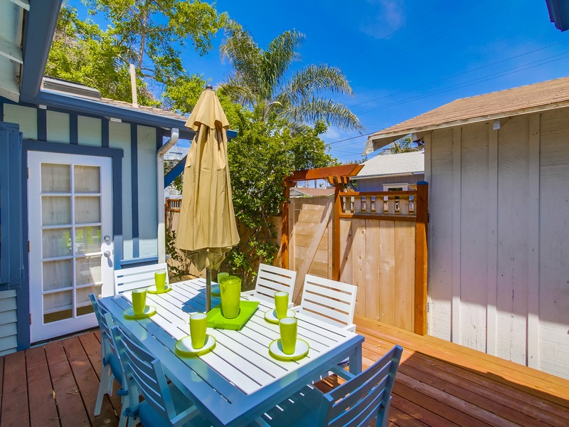 Backyard deck with table and chairs.