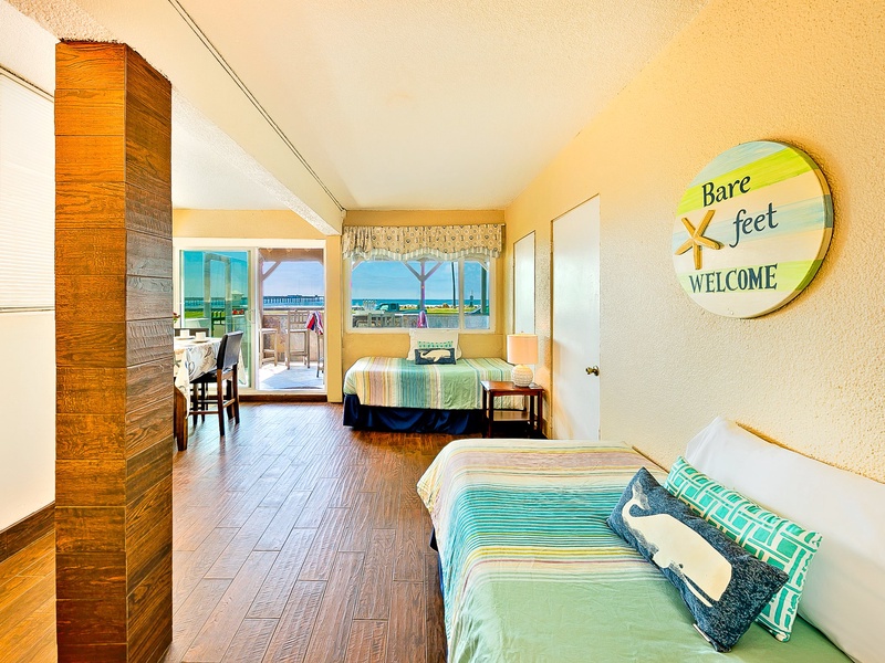 Back sun room with two twin beds and small dining table
