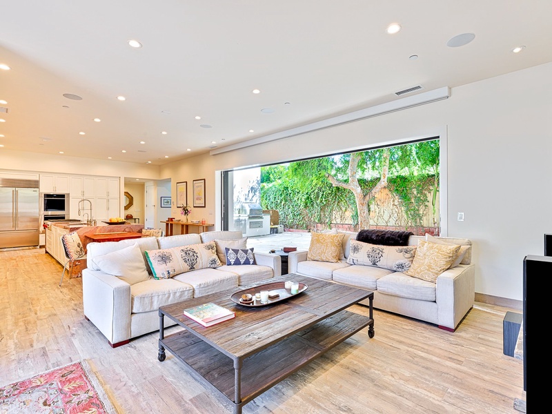 Accordion doors open the living room to the backyard.