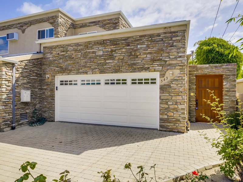 Garage and front entrance door to yard and front door.