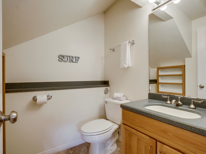 Small powder room under the stairs.