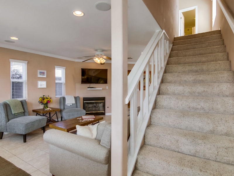 Stairs off living room leading to upstairs bedrooms.