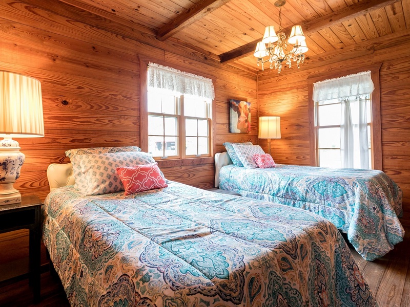 Two lovely twin beds occupy the downstairs bedroom