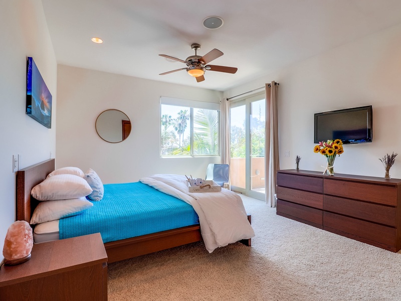 Slider in master bedroom opens up onto balcony.