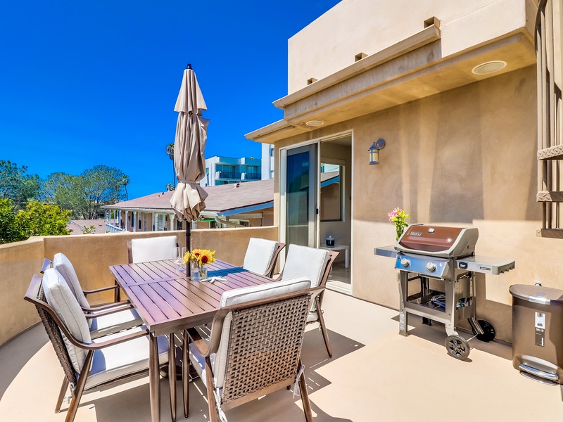 BBQ and seating on second level patio for outdoor entertaining.