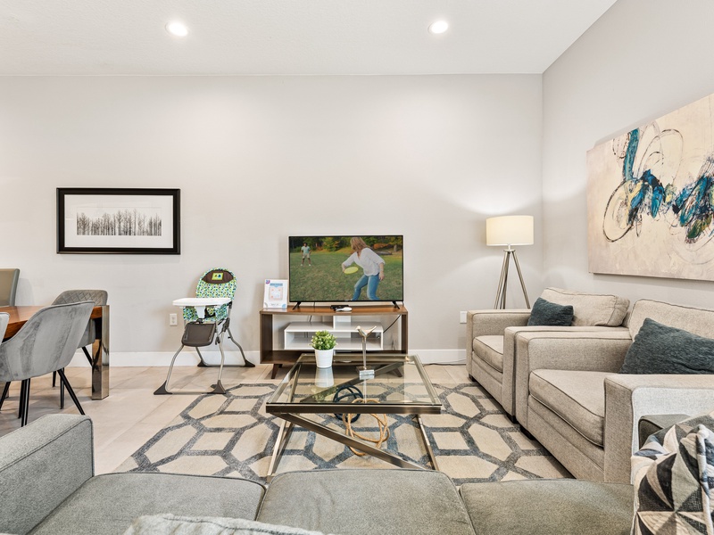 Have a cozy movie night in our living room, featuring a comfy sofa and a large smart TV perfect for relaxing after a day at the parks.