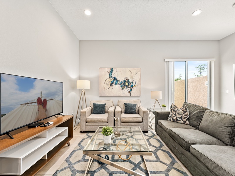 Have a cozy movie night in our living room, featuring a comfy sofa and a large smart TV perfect for relaxing after a day at the parks.