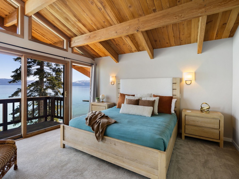 Primary king suite with private balcony, vaulted ceilings, and an ensuite bath