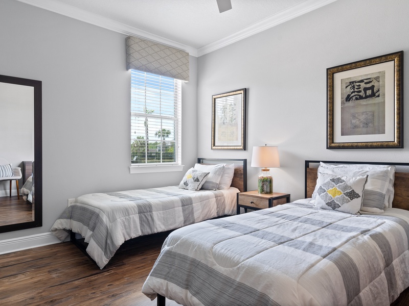 Second guest room, also located in the first floor, features two twin size beds and shared bathroom.