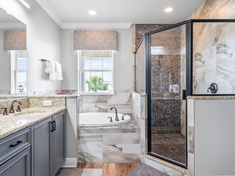 Stunning master bathroom with double vanity, shower and bathtub.