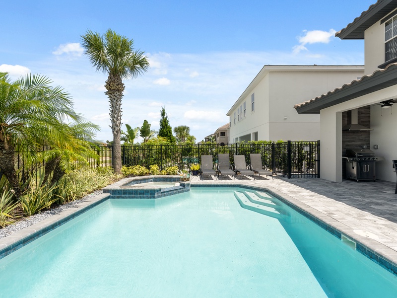 The private pool features lounge chairs, perfect for unwinding after a long day at the parks.