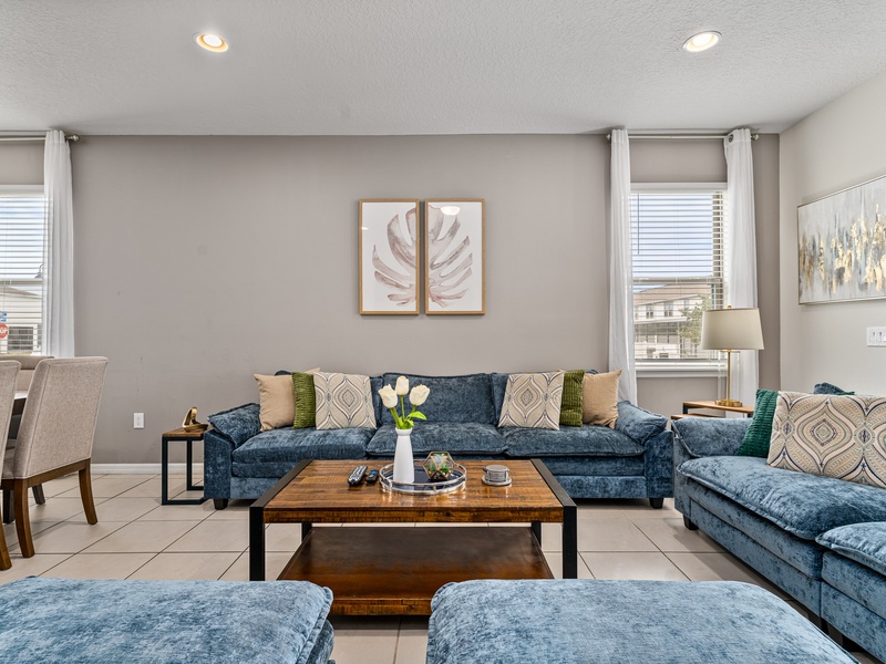 Our living room is equipped with a TV and ample plush seating, perfect for relaxation and entertainment.