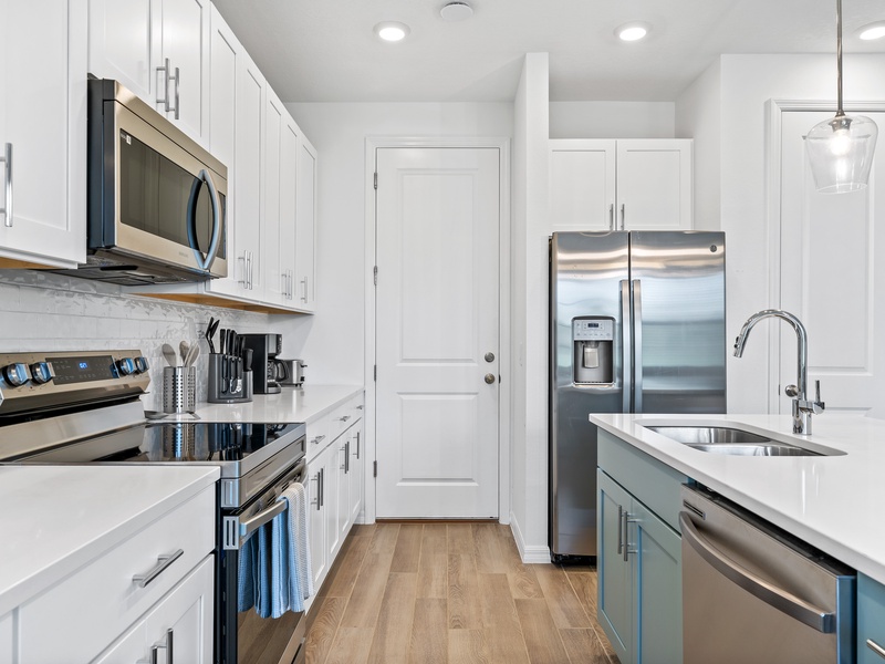 The kitchen features stainless steel appliances with all you need to prepare delicious meals.