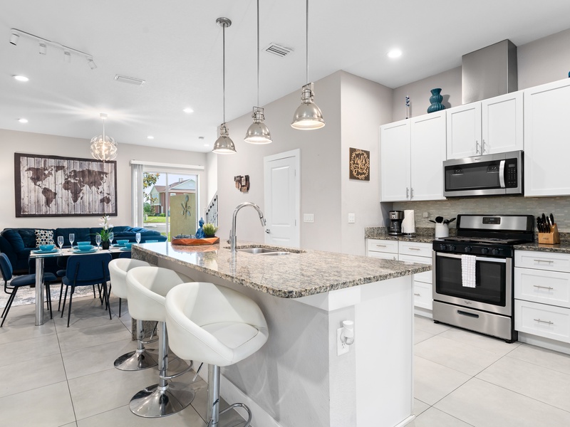 Cook with ease in a kitchen featuring stainless steel appliances and all essentials.
