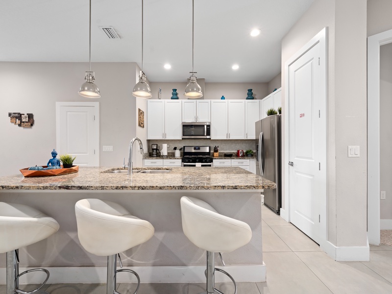 Fully equipped kitchen with modern stainless steel appliances.