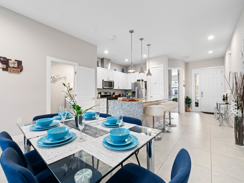 Featuring an open-concept layout that seamlessly connects the dining area, living room, and kitchen, for a practical and inviting space for gatherings.