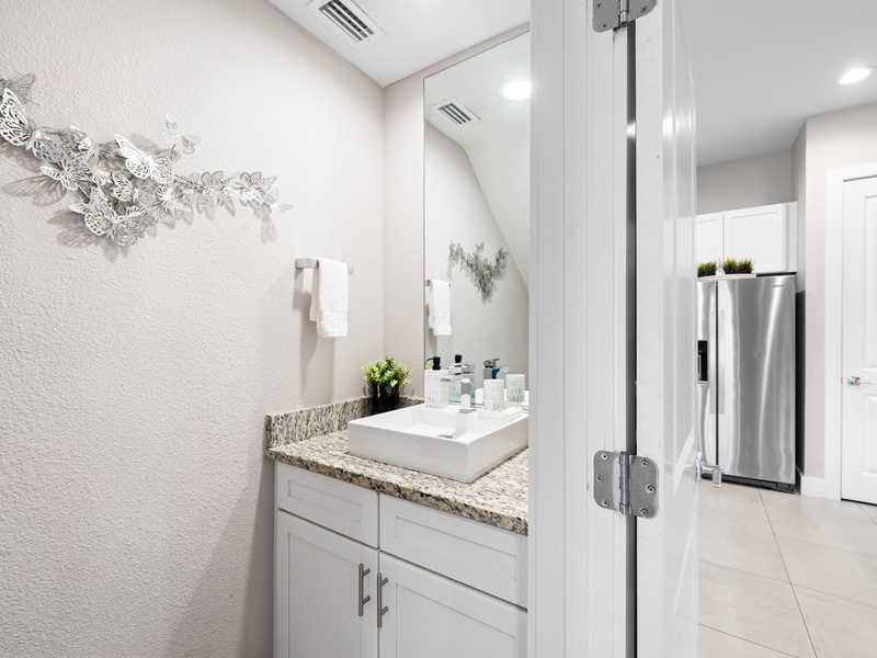 A convenient half-bathroom is located just off the living room, perfect for guests.
