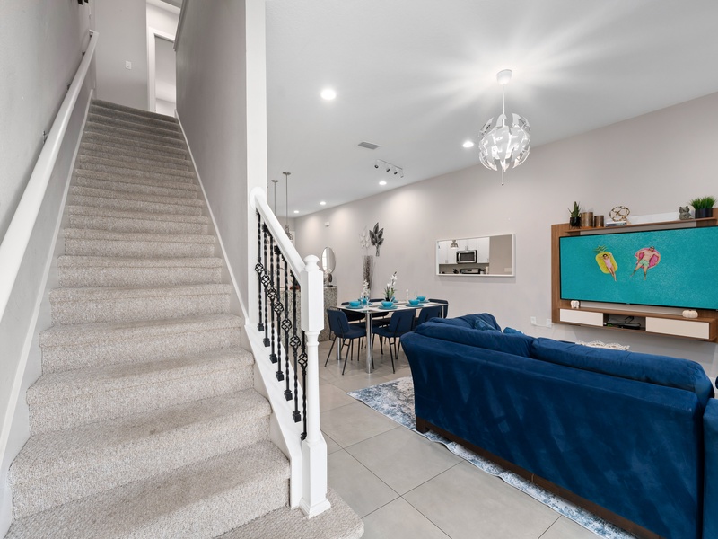Featuring an open-concept layout that seamlessly connects the dining area, living room, and kitchen, for a practical and inviting space for gatherings.