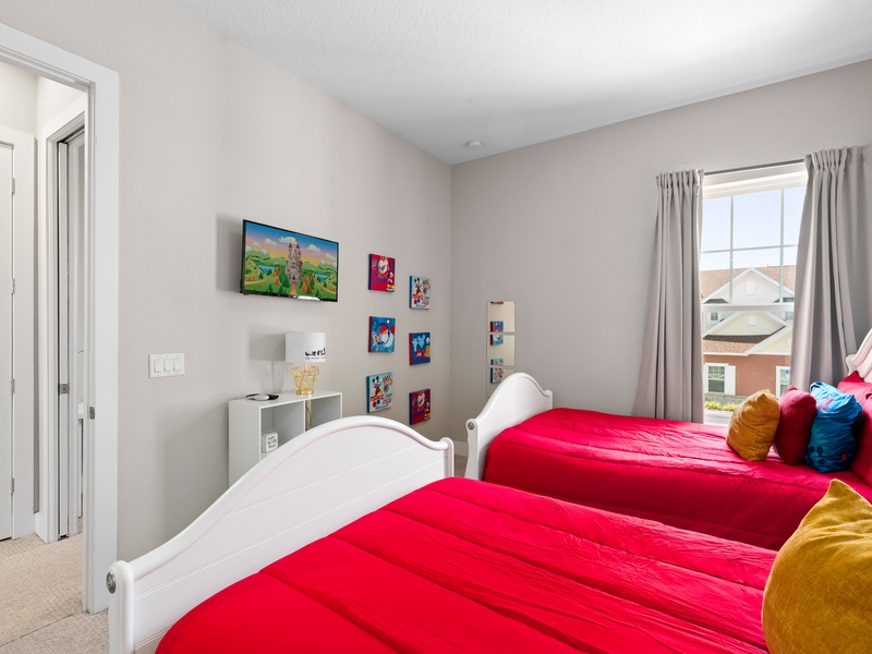 This bedroom is also equipped with a TV and an ensuite bathroom for added comfort and privacy.
