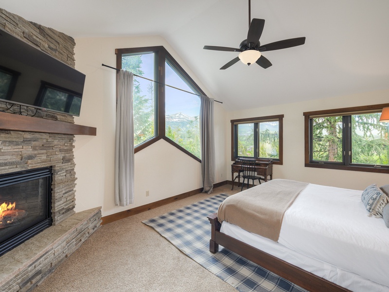 Primary Bedroom (Level 3): King bed, gas fireplace, walk-in closet, and ensuite bath with walk-in shower, bath tub, and toilet; access to deck with hot tub.