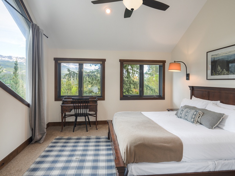 Primary Bedroom (Level 3): King bed, gas fireplace, walk-in closet, and ensuite bath with walk-in shower, bath tub, and toilet; access to deck with hot tub.