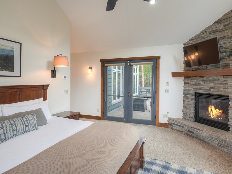 Primary Bedroom (Level 3): King bed, gas fireplace, walk-in closet, and ensuite bath with walk-in shower, bath tub, and toilet; access to deck with hot tub.
