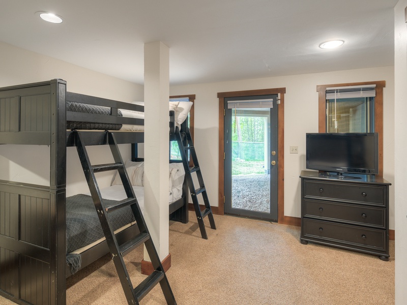 Seventh Bedroom (Level 1): One twin-over twin bunk bed one twin-over-full bunk bed; covered terrace access, and TV.