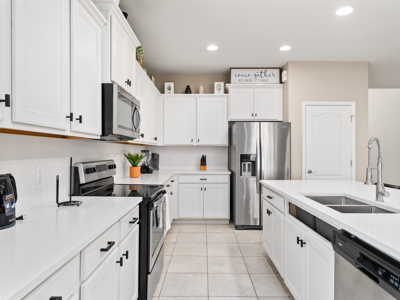 Fully equipped kitchens with stainless steel appliances.