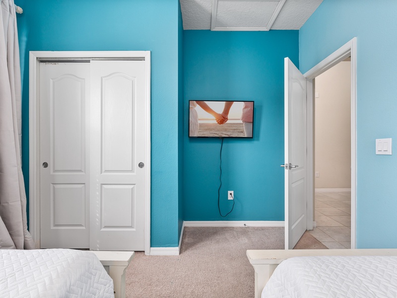 This bedroom comes with its own TV and closet space.