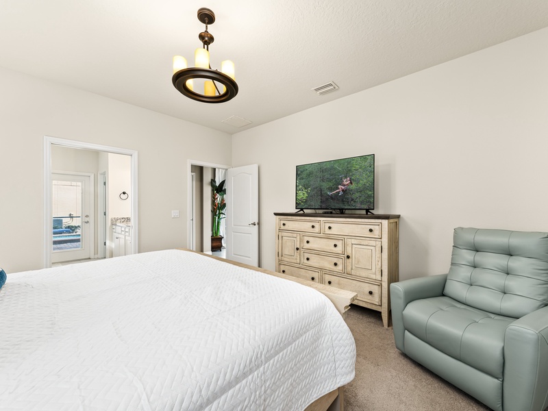This bedroom comes with its own TV and closet space.