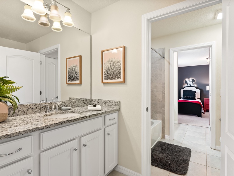 The semi private bathroom features a private vanity for earch room.