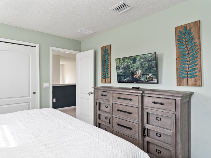 This bedroom comes with its own TV and closet space.