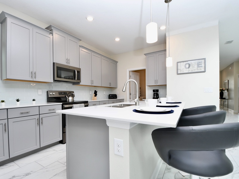 Fully equipped kitchen featuring sleek stainless steel appliances.
