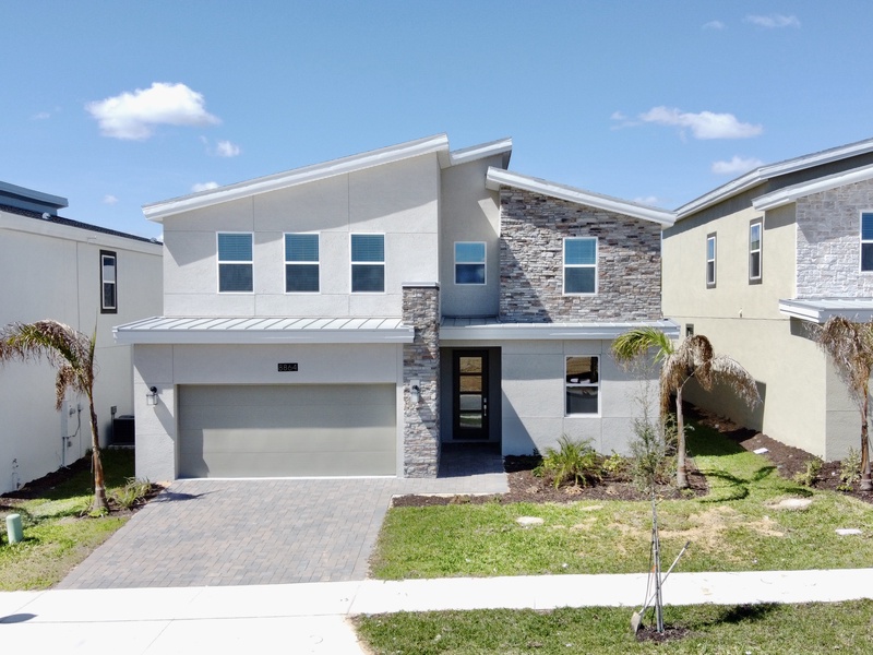 Four parking spaces are available in the driveway and garage. Additional guest parking is also available near the house.