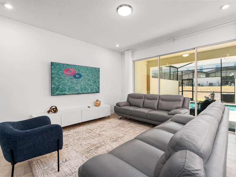 Enjoy a movie night in our cozy living room, complete with a large-screen TV and comfortable plush seating.