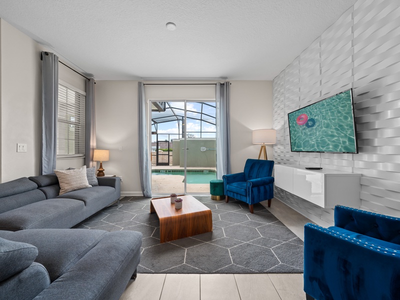 Enjoy cozy movie nights in our living room, featuring ample plush seating,  TV, and a warm, inviting atmosphere.