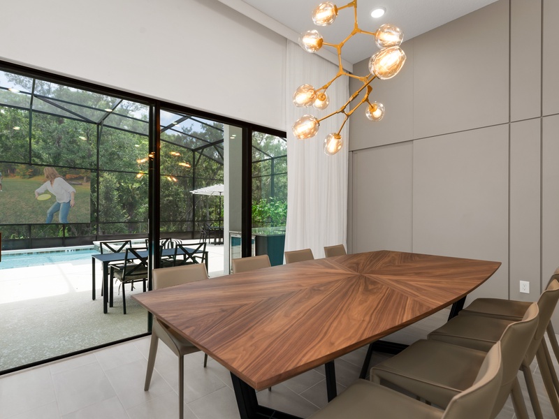 Our dining area features two beautifully designed tables that seat large groups comfortably. You'll also find a convenient bar-height counter with additional seating.