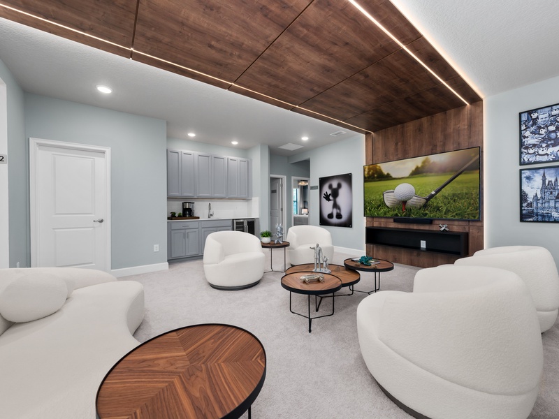 Designed for relaxation and connection, this lounge offers a mini bar area, modern furnishings, and a warm, inviting atmosphere.