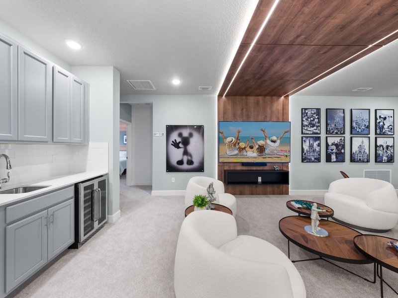 Designed for relaxation and connection, this lounge offers a mini bar area, modern furnishings, and a warm, inviting atmosphere.
