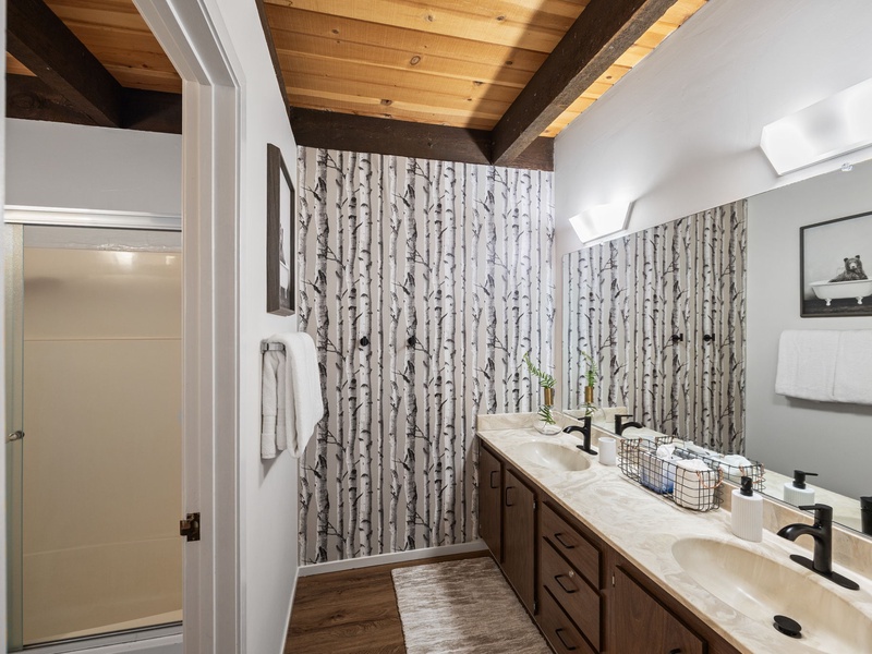 Bathroom #1 is shared by the first and second bedroom and offers a  stand up shower and double sink vanity