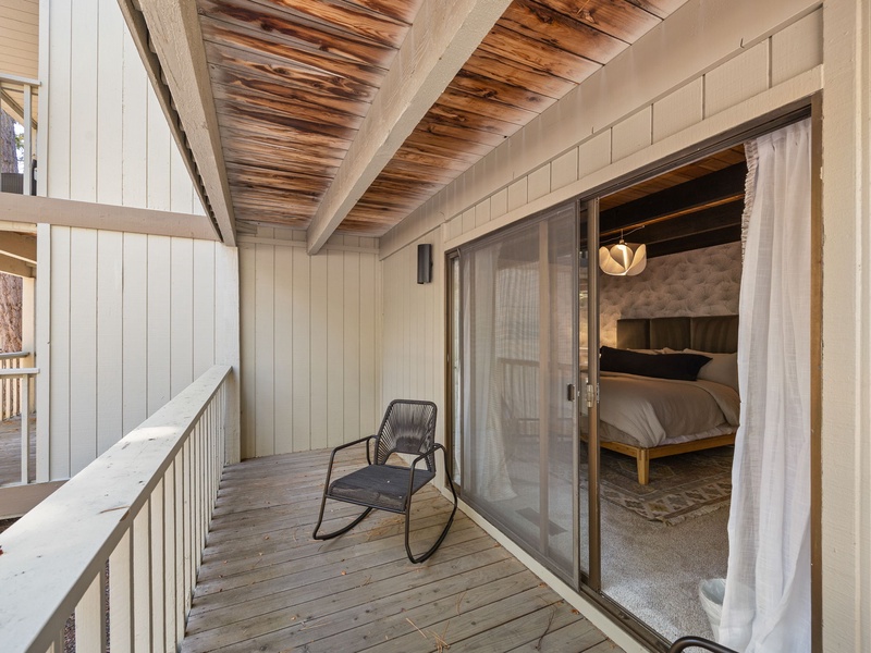 Balcony located off Bedroom #1 with an outdoor rocking chair
