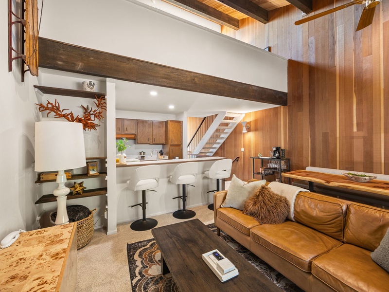 View of the kitchen from the main living area, with a breakfast bar for three