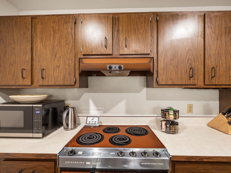 An electric range and full sized oven is offered for all of your cooking needs