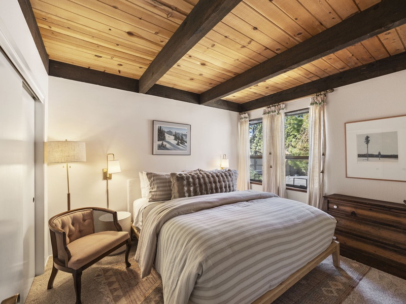 Bedroom #2 - King sized comforts, a sitting chair, and shared bath located on the ground floor