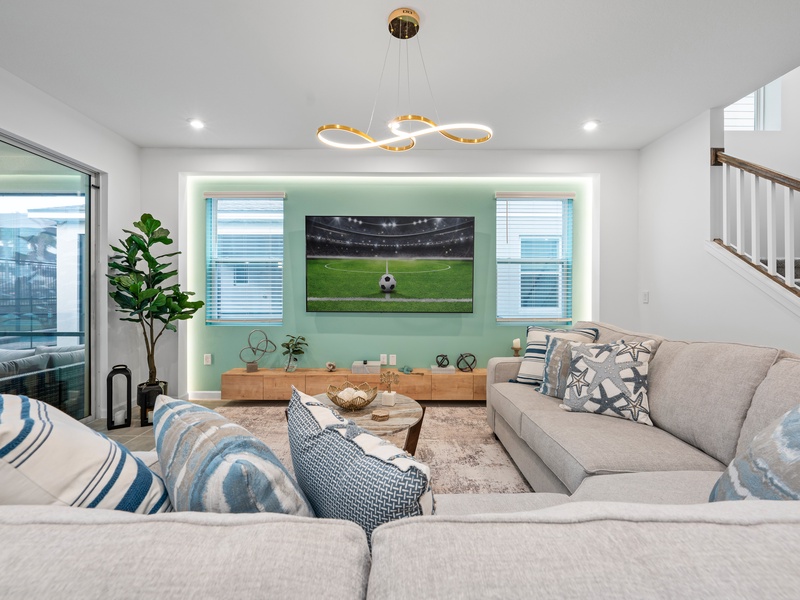 Enjoy a movie night in our cozy living room, complete with a large-screen TV and comfortable plush seating.