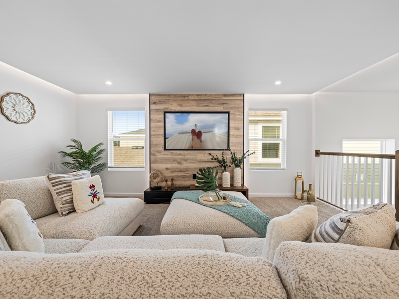 Enjoy a movie night in our cozy second living room, complete with a large-screen TV and comfortable plush seating.